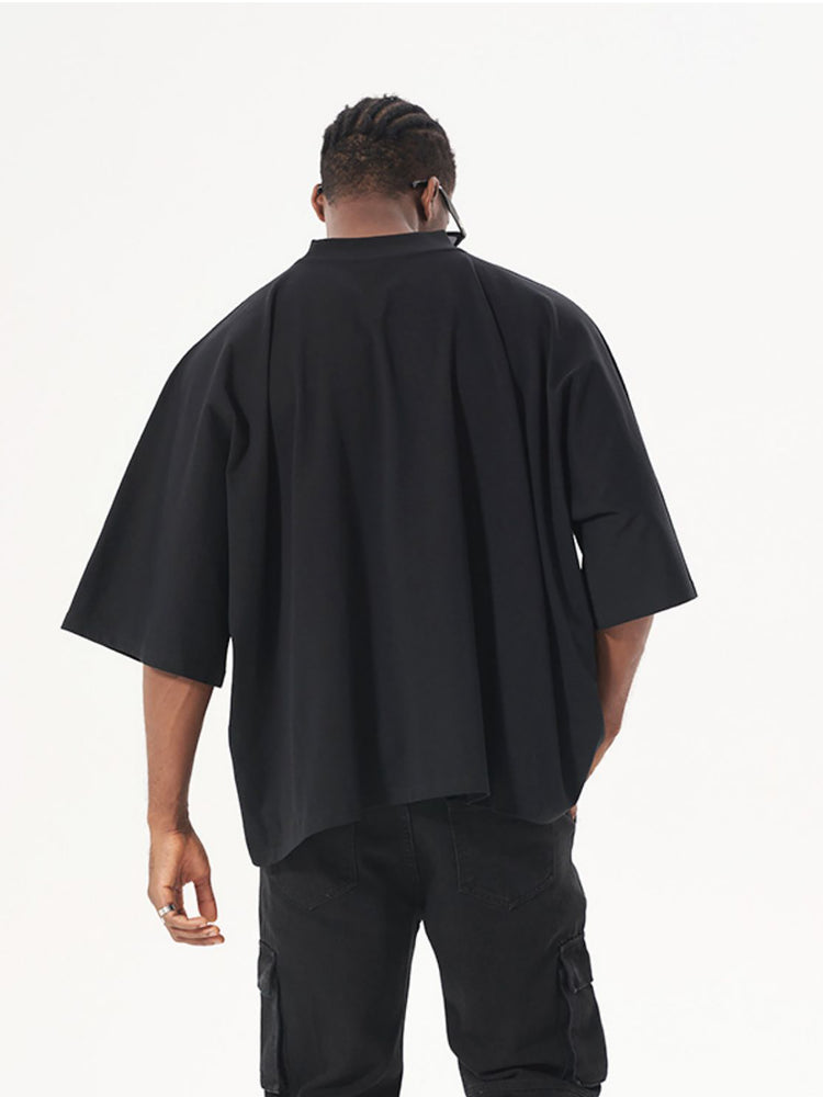 Back view of a person wearing an Oversized Boxy Graphic Tee in black, showcasing its relaxed fit and modern style.